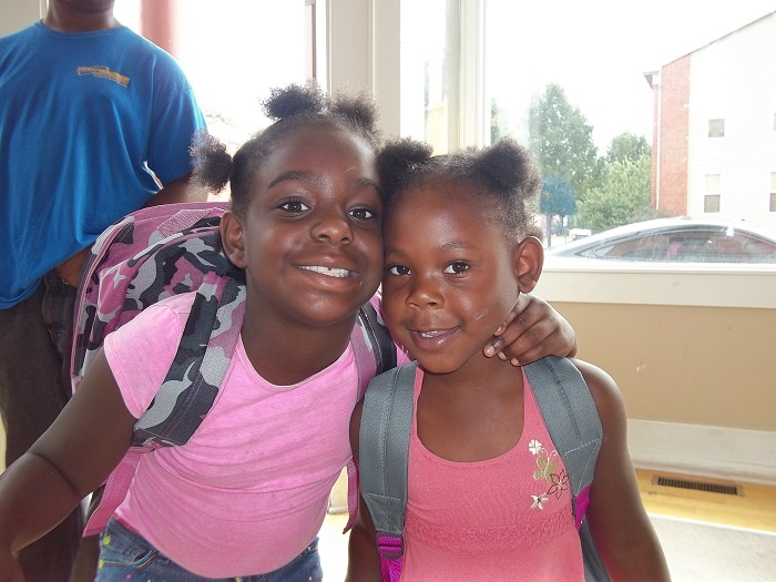 Two young girls smiling at the camera